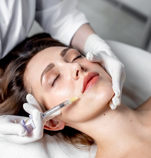 Medical aesthetic injection being applied to the face